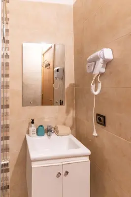 a bathroom with a white sink and a mirror at Suite Elegante 2 chambres Confort & Style Marrakech in Oulad Akkou