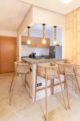 a kitchen with a table and chairs in a room at Suite Elegante 2 chambres Confort & Style Marrakech in Oulad Akkou