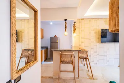 a kitchen with a table and chairs and a mirror at Suite Elegante 2 chambres Confort & Style Marrakech in Oulad Akkou