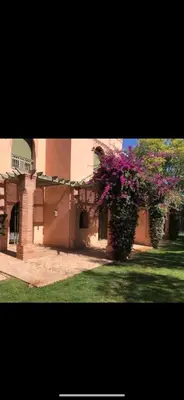 a building with a bush with purple flowers on it at Pure havre de paix à Marrakech in Marrakech