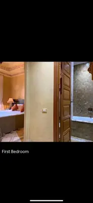 a room with a bedroom with a bed and a ladder at Pure havre de paix à Marrakech in Marrakech