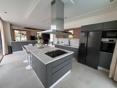 a large kitchen with a stove and a refrigerator at luxury 5 bedroom home in Marrakech