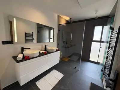 a bathroom with two sinks and a mirror at luxury 5 bedroom home in Marrakech