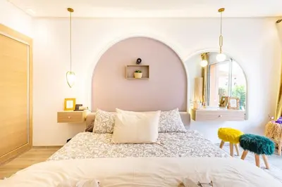 a bedroom with a large bed and a mirror at Luxe et Élégance au cœur de Marrakech in Marrakech