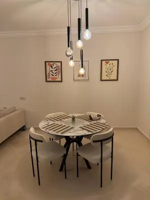 a dining room with a table and chairs at Pas disponible in Marrakech