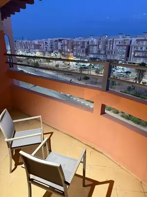 two chairs on a balcony with a view of a city at Pas disponible in Marrakech