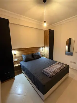 a bedroom with a bed and a mirror on the wall at Pas disponible in Marrakech