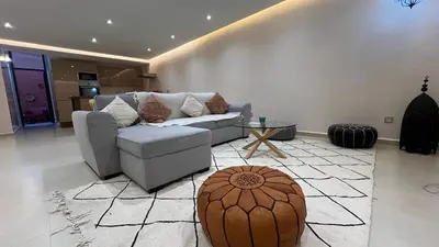 a living room with a couch and a table at Appartement Design près du Jardin Majorelle in Marrakech