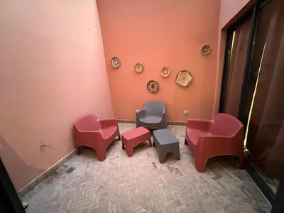 a room with red and pink chairs in a room at Appartement Design près du Jardin Majorelle in Marrakech