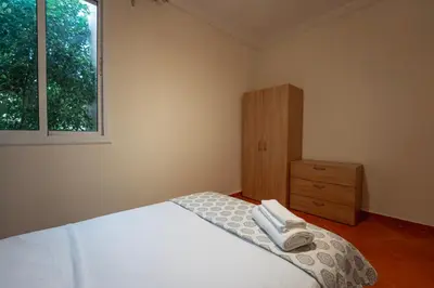 a bedroom with a bed and a dresser and a window at Charming Central 2 Bedroom Apartment with Pool Near Train Station in Marrakech