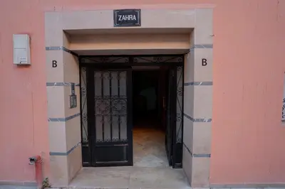 an entrance to a building with a black door at Charming Central 2 Bedroom Apartment with Pool Near Train Station in Marrakech
