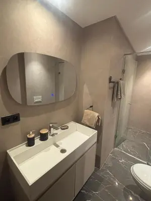 a bathroom with a white sink and a mirror at Elite garden in Marrakech