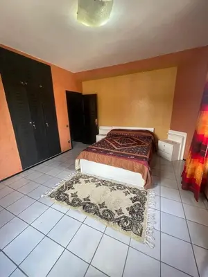 a bedroom with a bed and a rug on the floor at Majorele in Marrakech