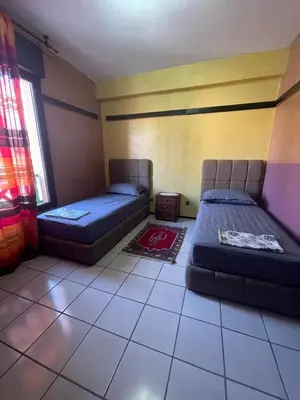 a room with two beds and a window at Majorele in Marrakech