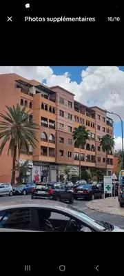 a large building with cars parked in front of it at andlous 4 in Marrakech