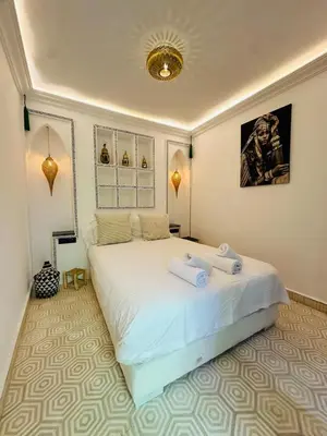 a bedroom with a large bed with towels on it at Riad Bayas - Comfort & Authenticity in Marrakech