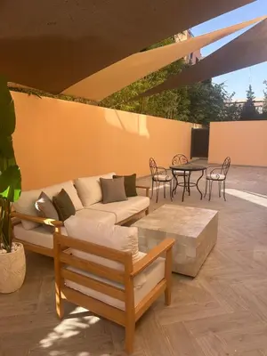 a living room with a couch and a table at Appartement chic Menara Mall piscine Rooftop in Marrakech