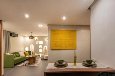 a living room with a green couch and a table at NEW !!! Organic design apartment-Center Marrakech getaway in Marrakech