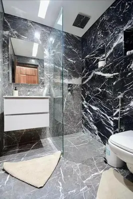 a bathroom with a toilet and a glass shower at Elegant Luxury Apartment in Marrakech