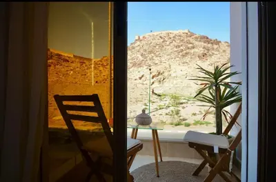 a room with a table and a chair and a window at Elegant Luxury Apartment in Marrakech
