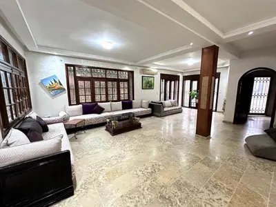 a large living room with couches and a fireplace at Spacious Villa with Private Pool in Oulad Lahsene