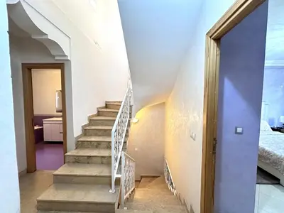 a staircase in a house with a blue door at Spacious Villa with Private Pool in Oulad Lahsene