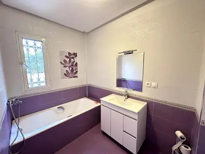 a bathroom with a tub and a sink and a bath tub at Spacious Villa with Private Pool in Oulad Lahsene