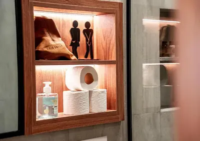a bathroom cabinet with toilet paper and a shelf at Terracotta Stay - Free parking in Marrakech