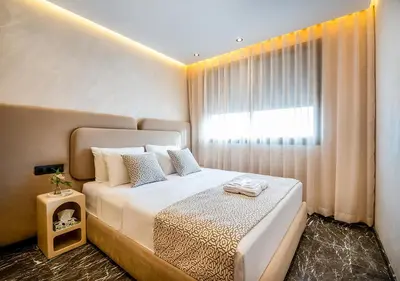 a bedroom with a large white bed with a window at Terracotta Stay - Free parking in Marrakech
