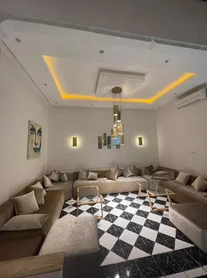 a living room with a couch and a checkered floor at Riad-style triplex in secure residence in Marrakech