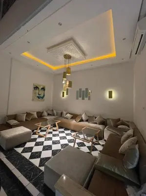a living room with a couch and a checkered floor at Riad-style triplex in secure residence in Marrakech