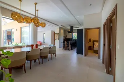 a dining room and living room with a table and chairs at Villa Jamila Marrakech in Segraga