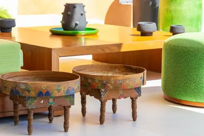 a table with two stools next to a table at Villa Jamila Marrakech in Segraga