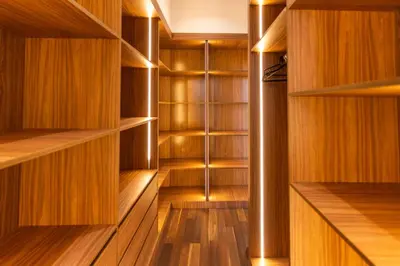 a walk in closet with wooden shelves and a pole at Luxury Villa with Heated Pool & Private cinema in Marrakech
