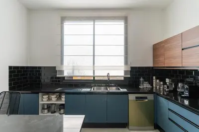 a kitchen with blue cabinets and a sink and a window at Luxury Villa with Heated Pool & Private cinema in Marrakech
