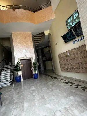 a lobby of a building with a door and potted plants at Guéliz Horizon - Central Apartment in Miramas2 in Marrakech