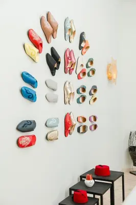 a wall with a bunch of shoes on a wall at Riad Les Sultanes Havre de paix avec jacuzzi prive in Marrakech
