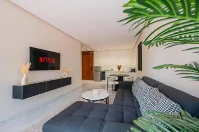 a living room with a couch and a tv at Modernite et Bien Etre au Coeur de la Ville in Marrakech