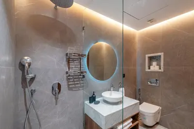 a bathroom with a sink and a shower with a mirror at Modernite et Bien Etre au Coeur de la Ville in Marrakech