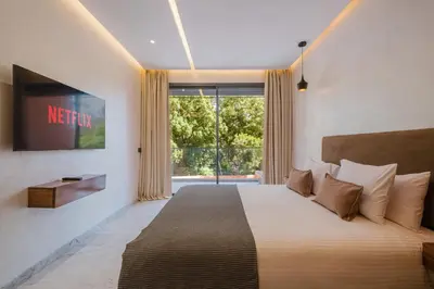 a bedroom with a bed and a large window at Modernite et Bien Etre au Coeur de la Ville in Marrakech