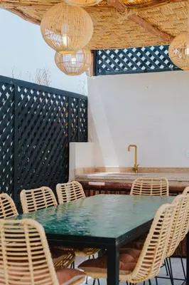 a dining room with a green table and chairs at Riad Imrani - piscine - 6 mn from Jamaa Al Fna in Marrakech