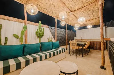 a living room with a couch and a table at Riad Imrani - piscine - 6 mn from Jamaa Al Fna in Marrakech