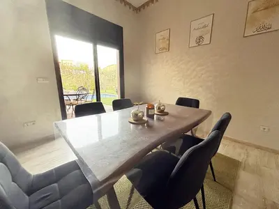 a dining room with a table and chairs at Villa Dar Ouladi - Marrakech - Pool & Rooftop in Marrakech