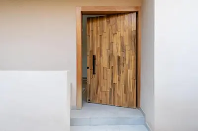 a wooden door in a room with a wall at Villa Nayma in Marrakech