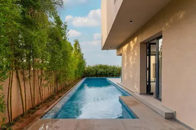 a swimming pool in the backyard of a house at Villa Nayma in Marrakech