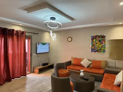 a living room with a couch and a tv at Opera 3 in Marrakech