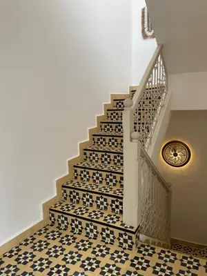 a staircase with a black and white tile floor at Riad 4 chambres, Piscine, Pdj inclus in Marrakech