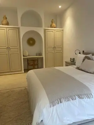 a bedroom with a large white bed and cabinets at Riad 4 chambres, Piscine, Pdj inclus in Marrakech