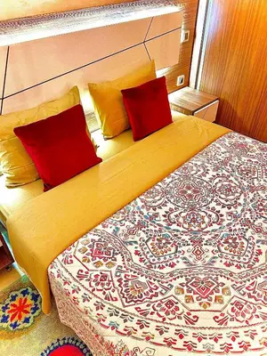a bedroom with a large bed with two red pillows at Lilia apartment marrakech in Marrakech