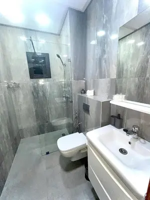 a bathroom with a shower and a toilet and a sink at Lilia apartment marrakech in Marrakech